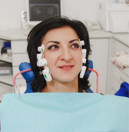 Woman with diagnostic electrodes on the sides of her jaws