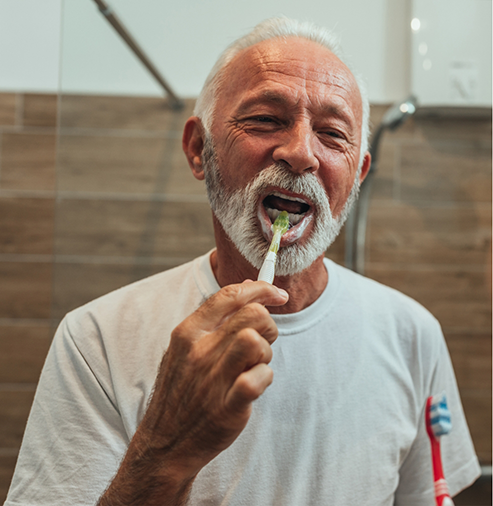 Senior man brushing his teeth
