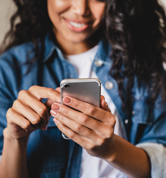 Smiling woman scrolling on her phone