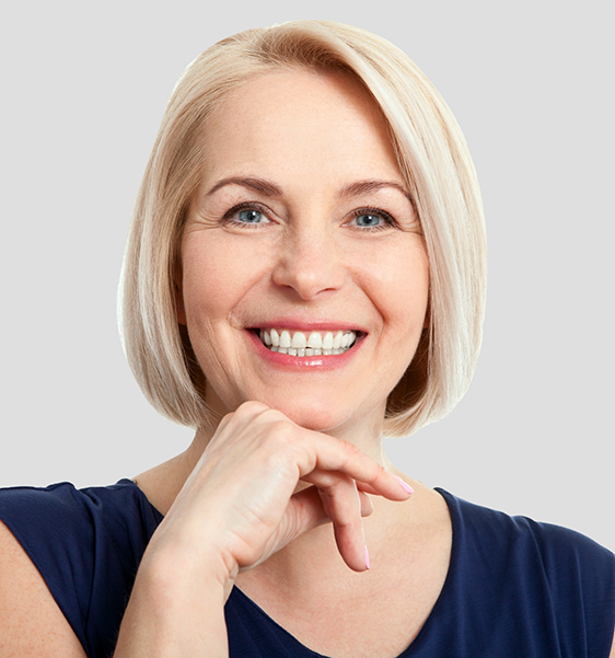 Blonde woman smiling confidently after cosmetic dentistry in Alexandria