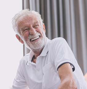 Smiling senior man in a white polo shirt