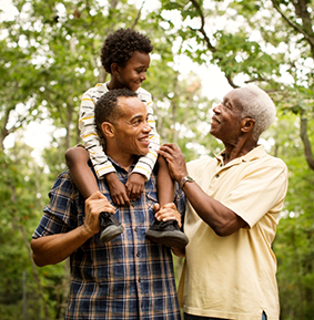 Three generations of men in the woods