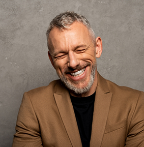 Smiling senior man in a light brown dinner jacket