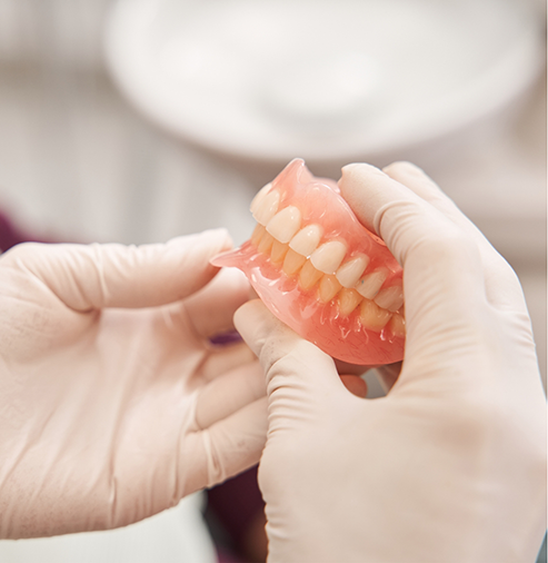 Dentist holding a set of dentures