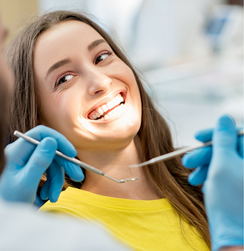 Woman smiling at her dentist during a checkup