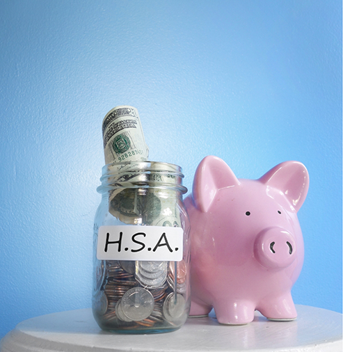 Jar of cash next to a piggy bank