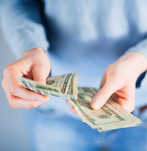 Person counting dollar bills