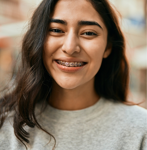 Young woman smiling with braces