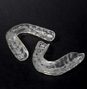 Two clear occlusal splint trays