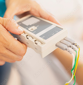 Hands holding a small box with buttons and wires